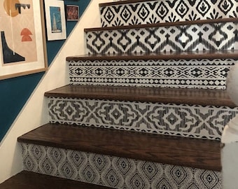 May include: Wooden staircase with black and white patterned adhesive tape on each step. The tape features geometric designs, including chevron, ikat, and diamond patterns.