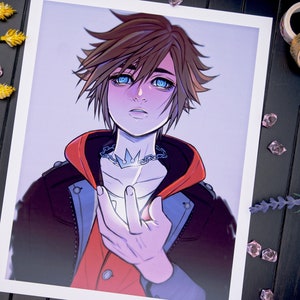 May include: A digital illustration of a young person with brown hair, blue eyes, and a crown necklace. They are wearing a black jacket with a red hood and a white shirt. The person is holding their hand out, and a bright light is emanating from it.