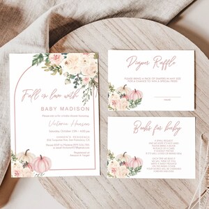 May include: A baby shower invitation with a floral design and pumpkins. The invitation reads "Fall in love with Baby Madison" and includes the name Victoria Hansen, the date 15th October, and the time 1:00-4:00 pm. The invitation also includes the address and RSVP information.