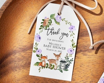 May include: Two white thank you tags with purple flowers, a deer, a fox, and a raccoon. The text on the tags reads "Thank you for showering Melissa's Baby Shower March 20, 2023".