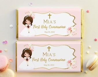 May include: Pink and gold chocolate bar wrappers with a floral design and a girl in a white dress holding a cross. The text on the wrapper reads "MIA'S First Holy Communion May 20, 2022".