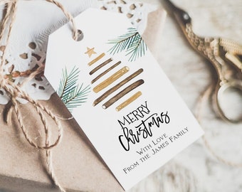 Könnte beinhalten: Ein weißer Geschenkanhänger mit einem goldenen Stern und einem stilisierten Weihnachtsbaum aus braunen und goldenen Stäbchen. Der Text "Merry Christmas" ist in schwarzer Kursivschrift geschrieben. Der Text "With Love From The James Family" ist in Schwarz unter dem Baum geschrieben.