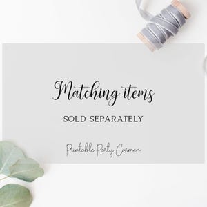 May include: A white card with the text "Matching items SOLD SEPARATELY" in black script. A spool of grey ribbon, scissors, and eucalyptus leaves are arranged around the card.