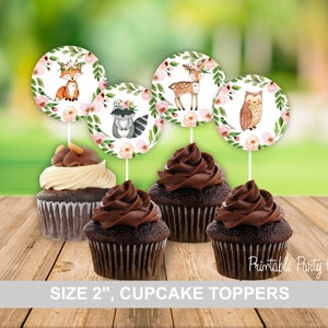 May include: Set of five 2-inch round cupcake toppers featuring woodland animals. The toppers are printed with a watercolor design of a fox, deer, raccoon, owl, and floral accents.  The toppers are perfect for a woodland-themed party.