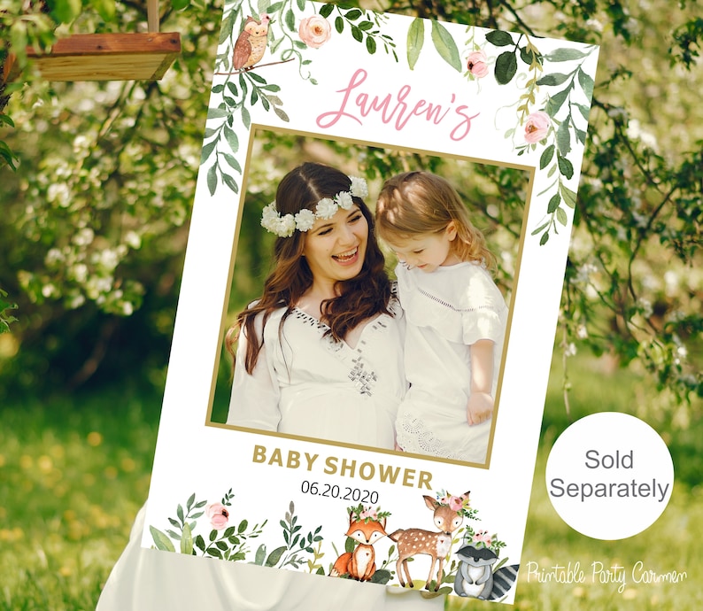 May include: A printable photo booth prop for a baby shower. The prop features a floral frame with a space for a photo, the text "Lauren's Baby Shower 06.20.2020", and a woodland animal theme with a fox, deer, and raccoon.