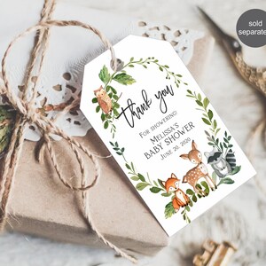 May include: A white thank you tag with a green leafy wreath and woodland animals. The text reads "Thank you" and "For showering! Melissa's Baby Shower June 20, 2020".