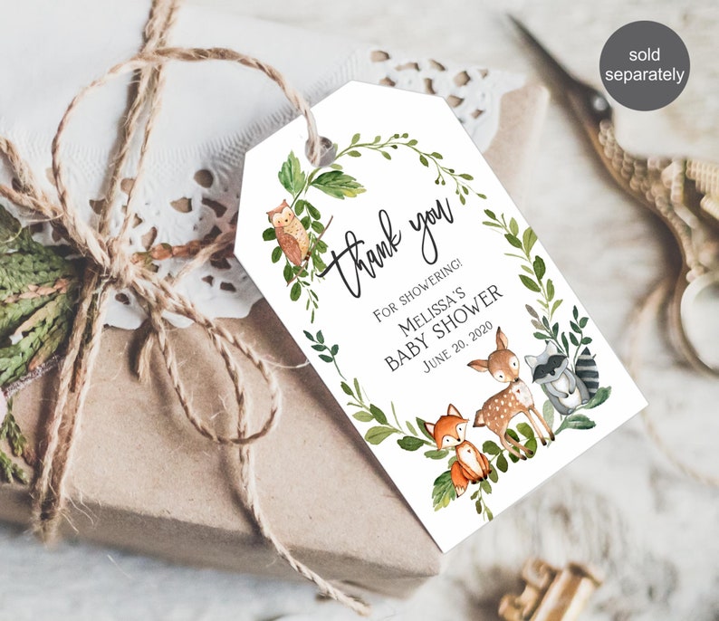 May include: A white thank you tag with a green leafy wreath and woodland animals. The text reads "Thank you" and "For showering! Melissa's Baby Shower June 20, 2020".
