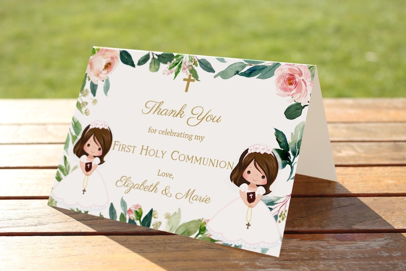 May include: Thank you card with a floral border and two illustrations of girls in white dresses holding rosaries. The text reads "Thank You for celebrating my First Holy Communion. Love, Elizabeth & Marie."