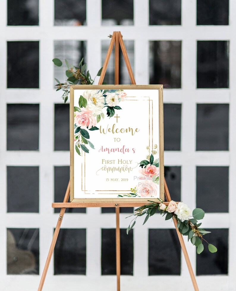 May include: Welcome to Amanda's First Holy Communion sign with a gold frame and floral design. The sign features a white background with pink and white flowers and greenery. The text is in gold and pink. The date is May 15, 2019.