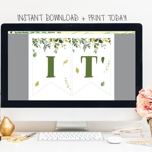 May include: A computer screen displaying a printable banner with the text "IT'" in green letters with a leafy green border. The banner is on a white background. The text "INSTANT DOWNLOAD + PRINT TODAY!" is displayed above the screen.