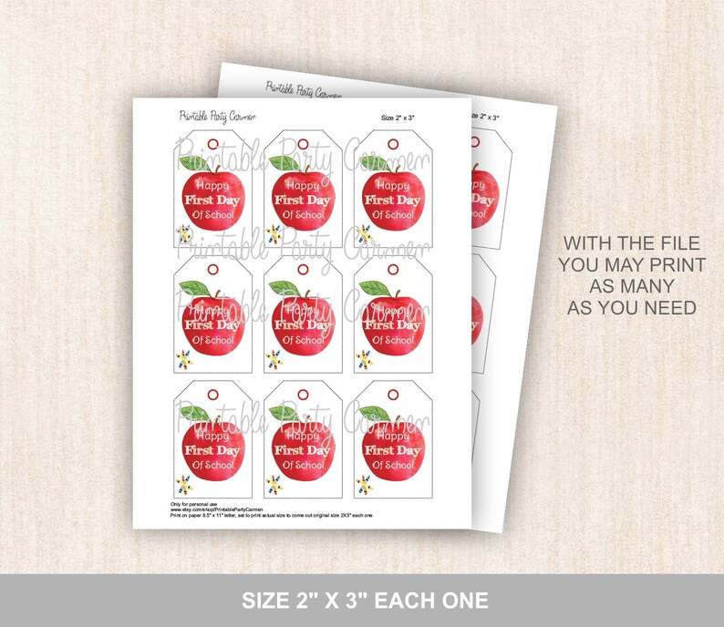 May include: Printable tags featuring a red apple with a green leaf and the text "Happy First Day of School". The tags are 2 inches by 3 inches and are designed for use as gift tags or classroom decorations.