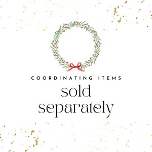 May include: A watercolor illustration of a green wreath with red berries and a red bow. The text "COORDINATING ITEMS sold separately" is below the wreath.