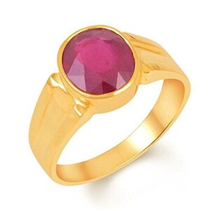 May include: A gold ring with a large, oval-shaped, red ruby gemstone.