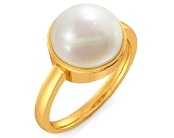 May include: A gold ring with a large white pearl set in a bezel setting.