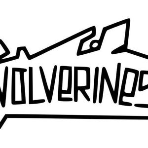 May include: Black and white graphic with the word "Wolverines!" in a stylized font. The word is set against a jagged mountain-like shape, with an exclamation point at the end.