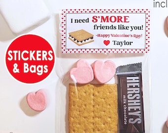 May include: Clear cellophane bag containing a graham cracker, Hershey's milk chocolate bar, and two heart-shaped marshmallows. A label reads "I need S'MORE friends like you! Happy Valentine's Day! Taylor." The image also includes a large white marshmallow and heart-shaped candies.