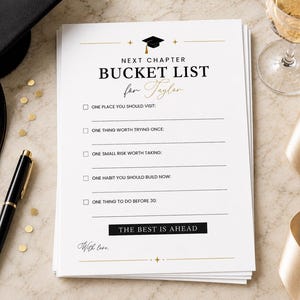 May include: A graduation-themed bucket list titled "Next Chapter Bucket List for Taylor" with a black graduation cap graphic. The list includes prompts for goals and is printed on white paper. A black pen, graduation cap, and champagne glass are also in the image.