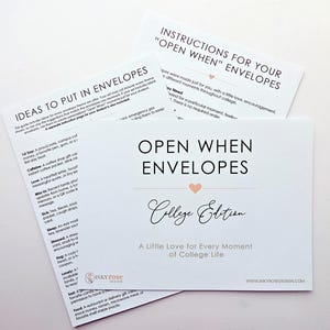 May include: A set of white instructional cards for Open When Envelopes College Edition. The cards feature black text, a small peach heart icon, and the Inky Rose Design logo. The text includes instructions, ideas for envelope contents, and a title.