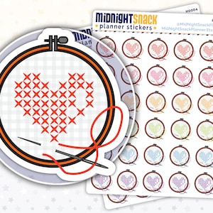 May include: A set of 36 planner stickers featuring a red heart cross-stitched in a hoop with a needle and thread. The stickers are arranged in rows of six, with each row featuring a different colour heart: pink, orange, yellow, green, blue, and purple.