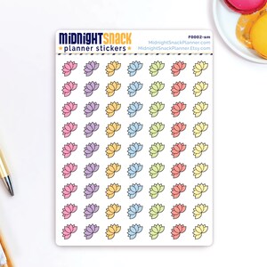 May include: A sheet of planner stickers featuring 36 pastel coloured lotus flower designs. The stickers are arranged in rows of four, with each row featuring a different colour. The colours are pink, purple, yellow, blue, green, and orange. The sheet is white with the text "MIDNIGHT SNACK planner stickers" at the top and "F0002-sm MidnightSnackPlanner.com MidnightSnackPlanner.Etsy.com" at the bottom.
