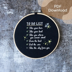 Puede incluir: Aro de bordado negro con texto blanco que dice "TO DO LIST" y una lista de tareas: "Take your love", "Take your land", "Take you where you cannot stand", "Burn the land", "Boil the sea", "Take the sky from you".