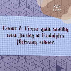 Pode incluir: Um sampler de ponto cruz branco com fio vermelho, marrom e verde. O texto diz "Comet & Vixen, quite stobby, were jeering at Rudolph's flickering schnoz."