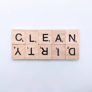 May include: A set of wooden letter tiles spelling out the words "CLEAN" and "DIRTY". Each tile has a letter and a point value.