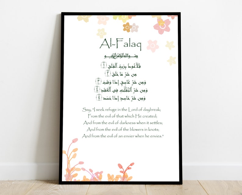 May include: A printable Islamic prayer poster featuring the Arabic text of the Al-Falaq Surah, translated into English. The poster has a green and white colour scheme with floral accents.