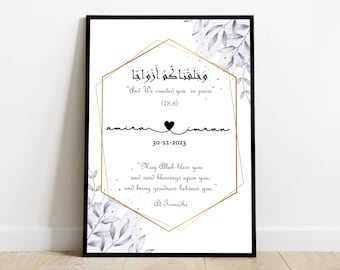 May include: A white printable art print with a gold geometric frame and floral accents. The print features an Arabic quote in black text, "And We created you in pairs" (78:8), and the names "Amira" and "Iman" with a heart symbol and the date "30-11-2023". The print also includes a quote in English, "May Allah bless you and send blessings upon you, and bring goodness between you." - Tirmidhi.