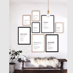 May include: A white wall with a collection of framed prints featuring Arabic words and their definitions. The prints are in black and white and have a minimalist aesthetic. A wooden bench with a white sheepskin throw sits in front of the wall.