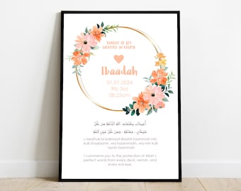 May include: A framed print featuring a floral wreath in peach and pink hues, encircling the name "Ibaadah" and birth details: 01.01.2024, 9lb 3oz, 08:25am. The print includes Arabic script and English text, all set against a white background.