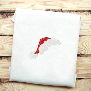 May include: White fabric with a red and white embroidered Santa hat.