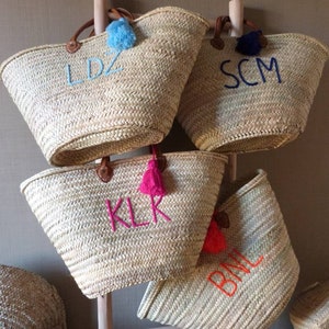 May include: Four straw tote bags with leather handles and colorful tassels. Each bag is personalized with embroidered initials: LDZ, SCM, KLK, and BML.