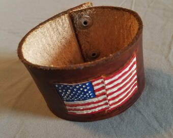 American flag hand tooled, and hand painted on a soft leather bracelet