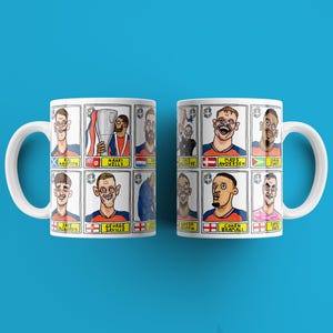 May include: Two white ceramic mugs with a blue background. Each mug features a grid of cartoon portraits of people, with names and flags. The mugs are identical, with white handles and a glossy finish. The mugs are likely themed around sports or a specific team.