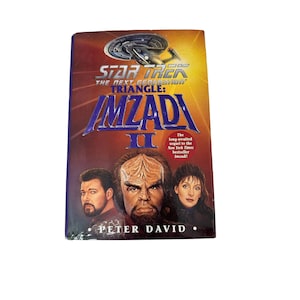 May include: A paperback book cover for the Star Trek: The Next Generation novel "Triangle: Imzadi II" by Peter David. The cover features a colorful illustration of three characters from the show: Worf, Deanna Troi, and  Data.