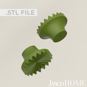 Könnte beinhalten: Zwei grüne 3D-gedruckte Knöpfe mit einem Sternburst-Design. Die Knöpfe sind für Möbel konzipiert und haben ein Loch in der Mitte zum Befestigen.