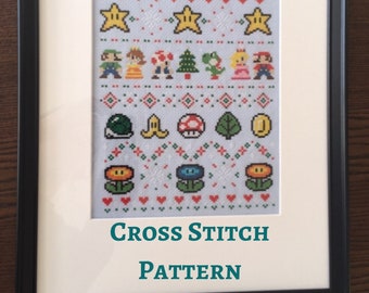 May include: A framed cross stitch pattern featuring characters and items from the Super Mario Bros. video game series. The pattern includes Mario, Luigi, Princess Peach, Toad, Yoshi, a Christmas tree, stars, mushrooms, a banana, a coin, and flowers.
