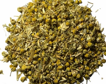 May include: A close-up of a pile of dried chamomile flowers and stems. The flowers are a pale yellow color and the stems are a light green color.