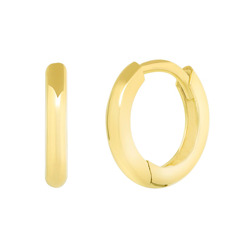 May include: A pair of gold hoop earrings with a hinged closure. The earrings are small and delicate, and they are perfect for everyday wear.