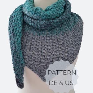 May include: A triangular crochet scarf featuring a textured stitch pattern with a color gradient transitioning from solid grey at the bottom to a blend of teal and grey at the top. The text PATTERN DE & US is printed in black on a white starburst shape.
