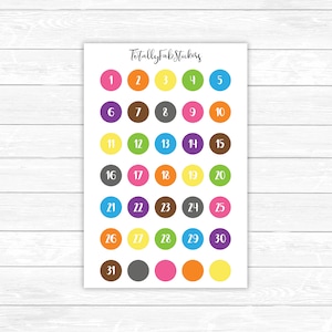 May include: A sheet of colorful round stickers with numbers 1 through 31. The stickers are arranged in five rows of six stickers each. The stickers are in various colors, including red, orange, yellow, green, blue, purple, pink, brown, and gray.