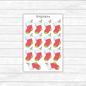 May include: A sheet of 16 Christmas stocking gift tags with the words "To" and "From" printed on each tag. The tags are red, white, and green.