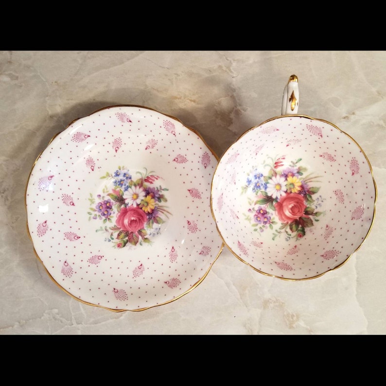 Beautiful pink shabby chic Paragon polka dot teacup and saucer set with cabbage roses and feathers throughout Perfect gift!