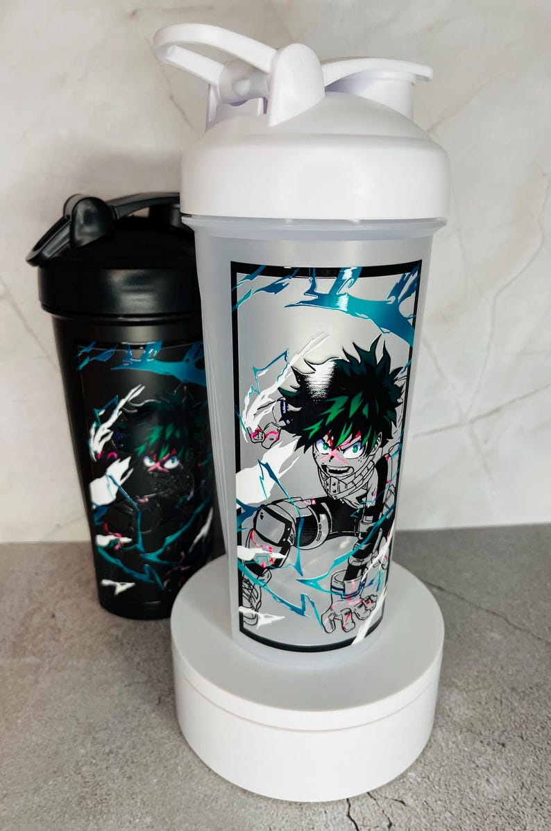 May include: Two white and black shaker bottles with a green and black anime character design. The character is surrounded by blue and white lightning bolts.