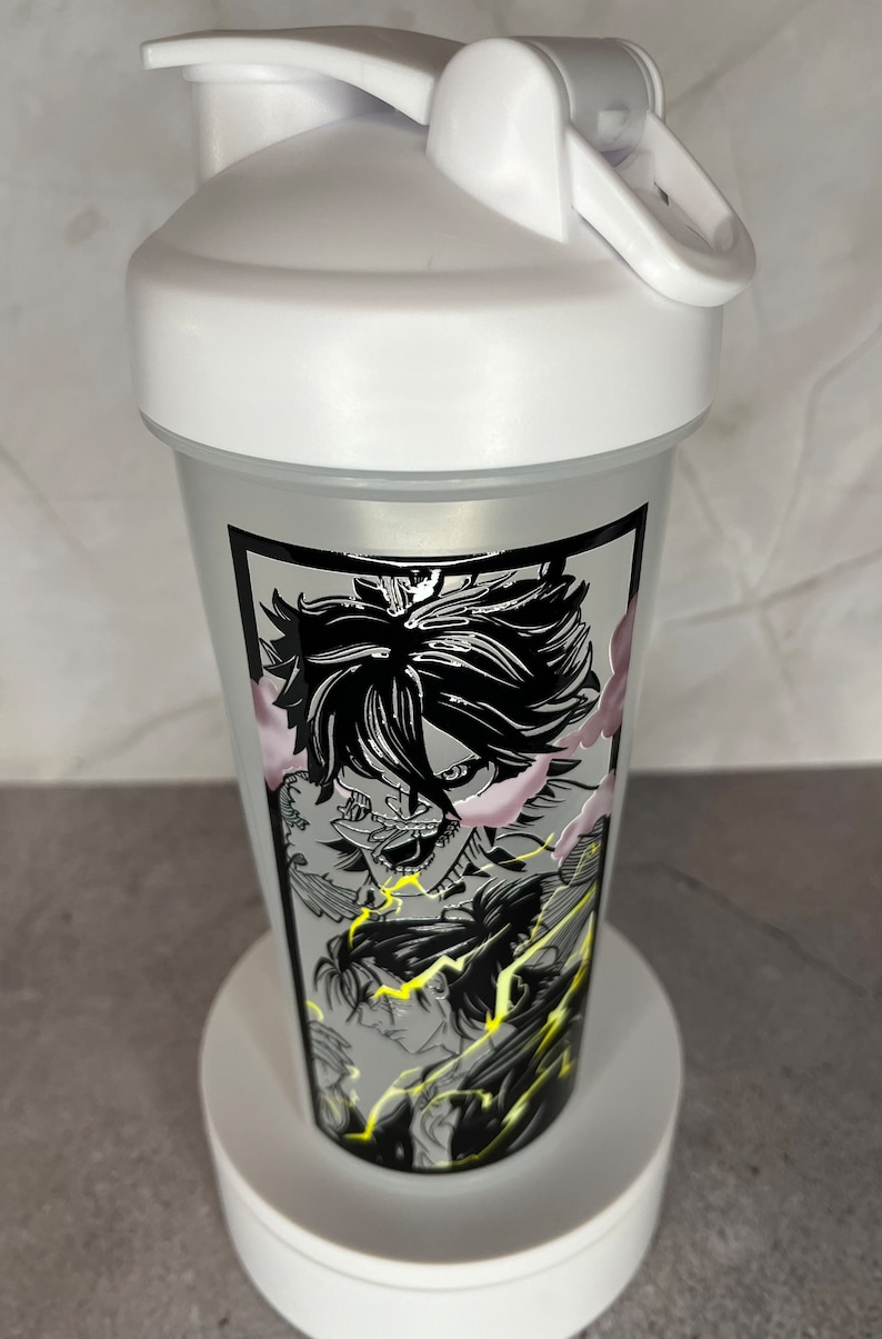 May include: White shaker bottle featuring a black and white graphic of an anime character with lightning bolts. The character has a fierce expression and is surrounded by smoke.