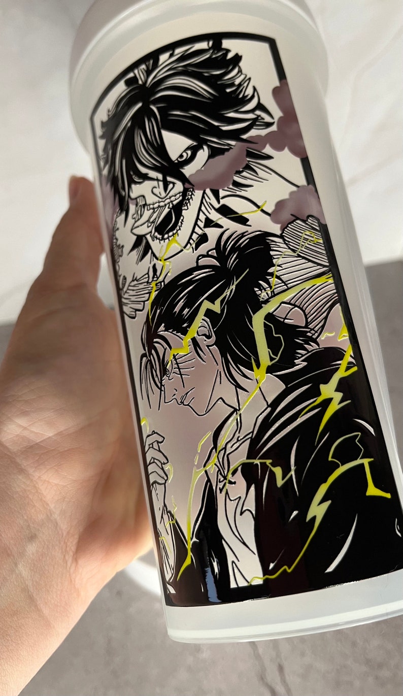 May include: Black and white illustration of two anime characters on a white tumbler. The characters are drawn in a manga style with dramatic poses and expressions. The background is filled with yellow lightning bolts.