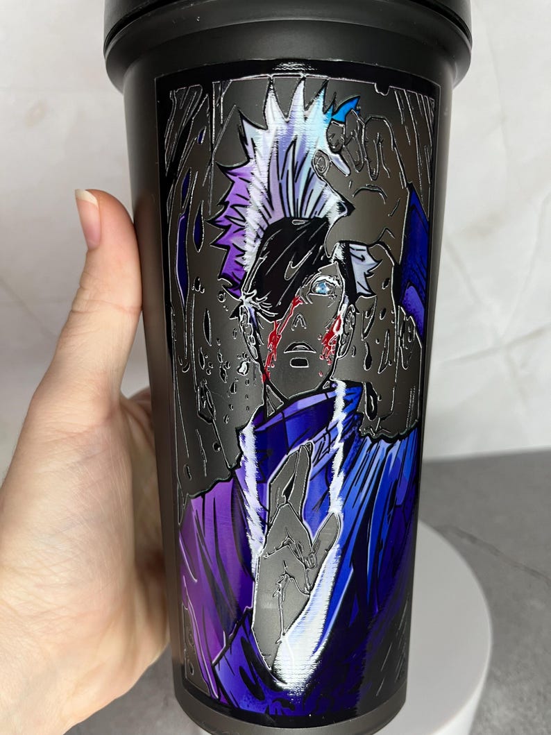 May include: A black stainless steel water bottle with a graphic of an anime character with white hair and blue eyes. The character is wearing a purple and blue outfit and has a white outline.