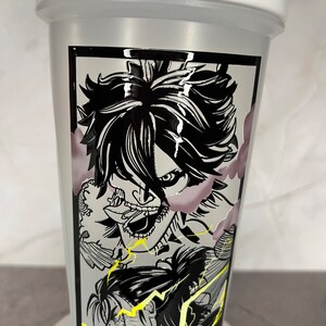 May include: A white shaker bottle featuring a black and white graphic of an anime character with a menacing expression. The character is surrounded by lightning bolts and clouds.