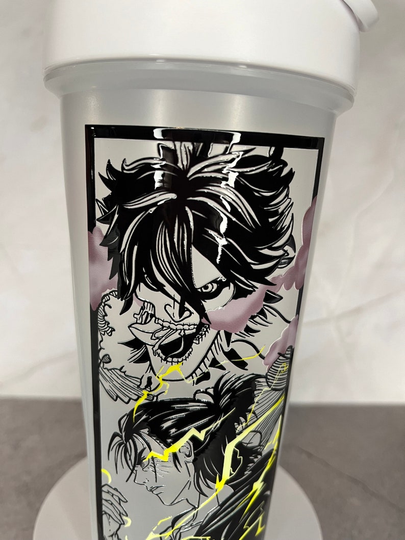 May include: A white shaker bottle featuring a black and white graphic of an anime character with a menacing expression. The character is surrounded by lightning bolts and clouds.